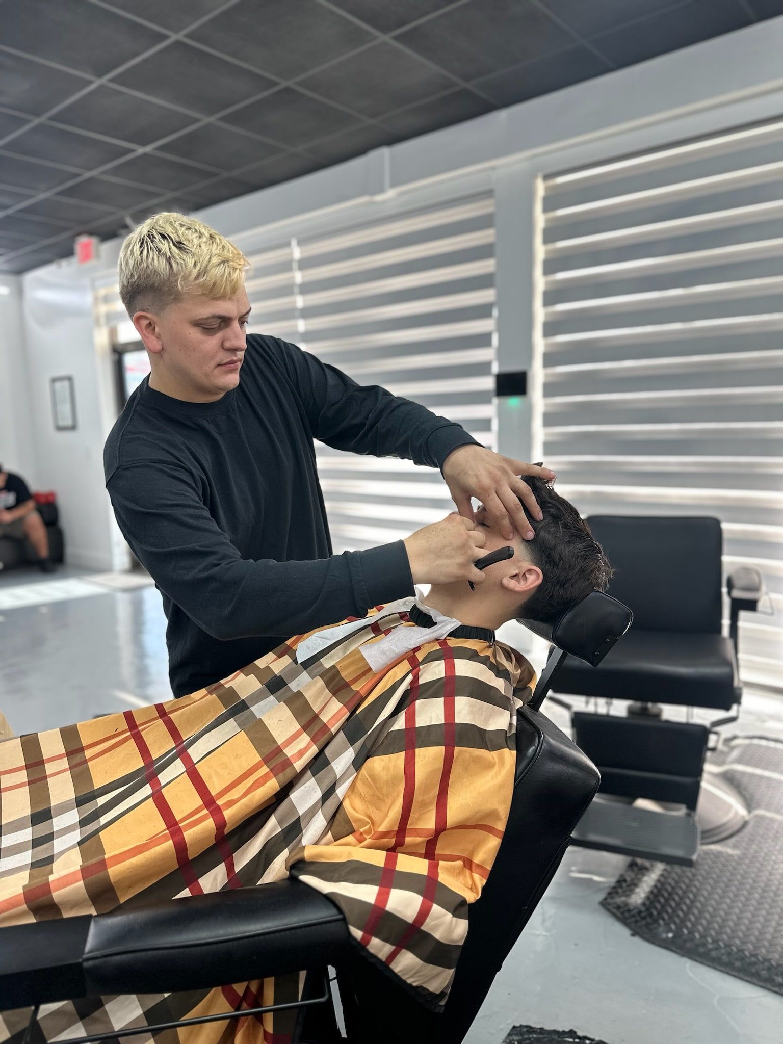 Sage The Barber lining up a haircut at his chair in Stuart, Florida
